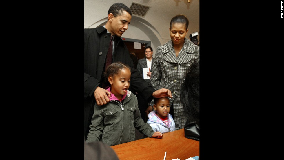 The Obamas check in with poll workers in Chicago in November 2004. Barack Obama would go on to win a US Senate seat.