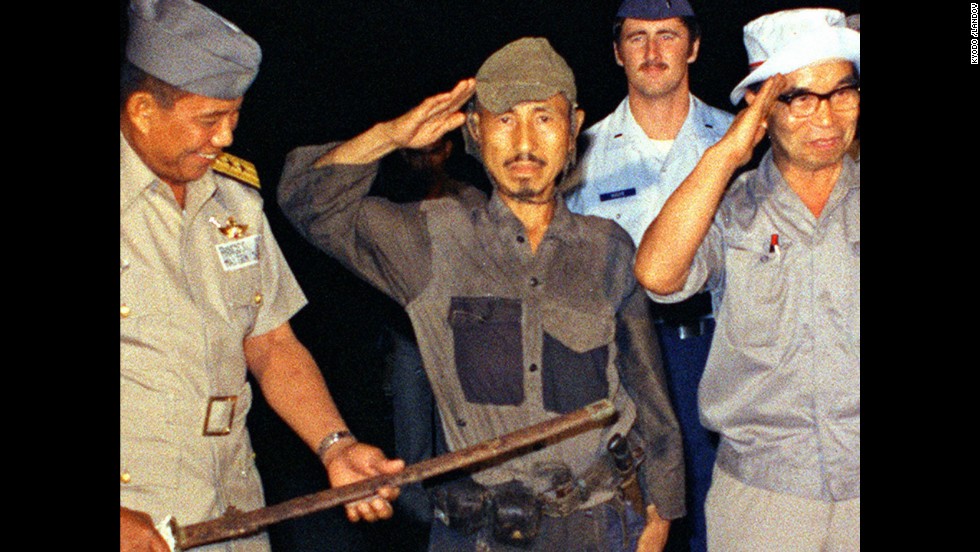 &lt;a href=&quot;http://www.cnn.com/2014/01/17/world/asia/japan-philippines-ww2-soldier-dies/index.html&quot;&gt;Hiroo Onoda&lt;/a&gt;, center, salutes after handing over his military sword on Lubang Island in the Philippines in March 1974. Onoda, a former intelligence officer in the Japanese army, had remained on the island for nearly 30 years, refusing to believe his country had surrendered in World War II. He died at a Tokyo hospital on January 16. He was 91.