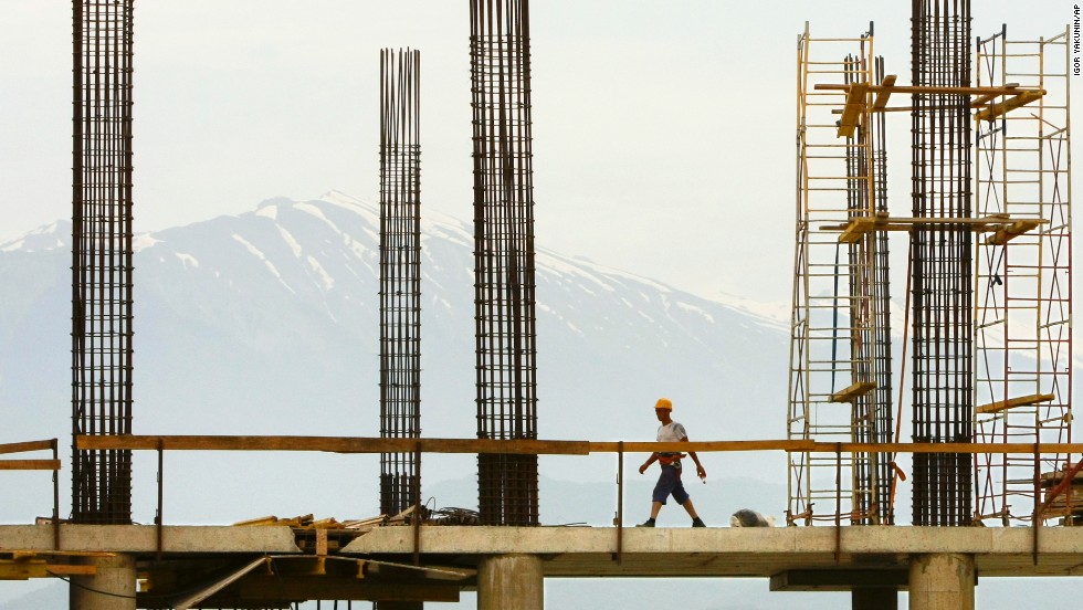 A construction worker walks on the top of the building site of the Bolshoi Ice Palace in Sochi in June 2010.