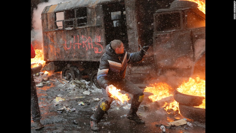A protester throws a Molotov cocktail during clashes with police in central Kiev.