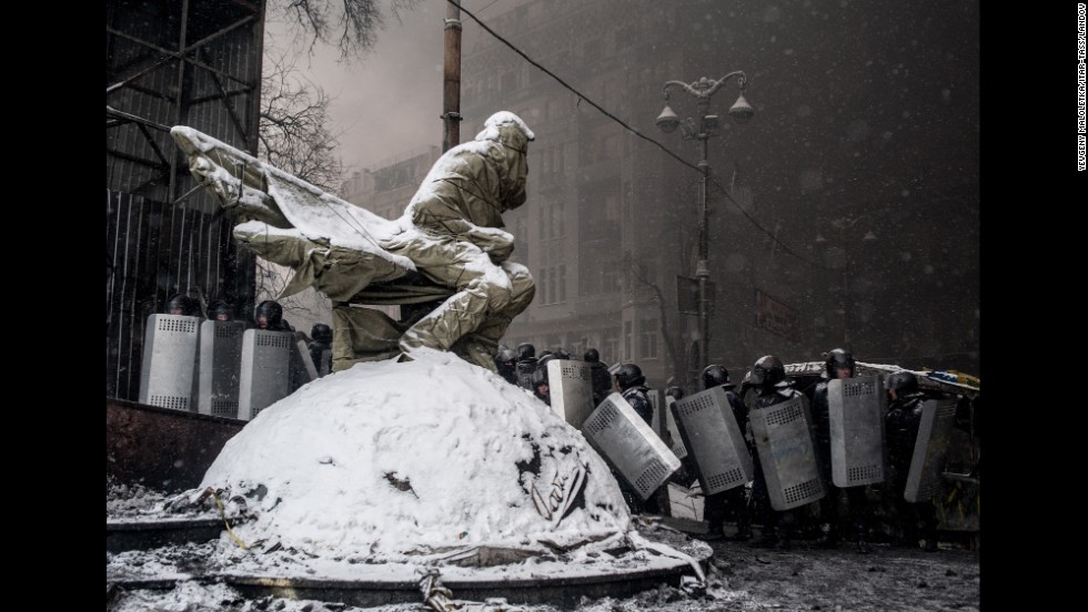 Riot police officers line up in Kiev during clashes on Wednesday, January 22.