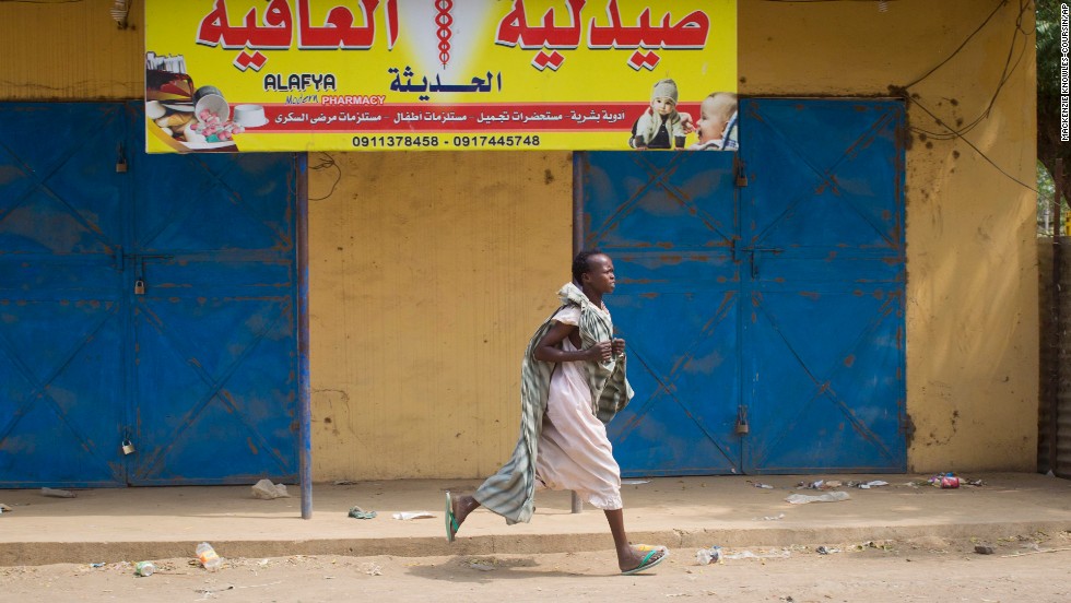 A woman runs through the street in Malakal as gunshots ring out a few streets over on January 21.