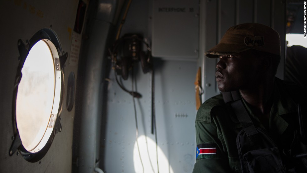 A Sudan People&#39;s Liberation Army soldier sits in a helicopter flying over Western Equatoria State on Tuesday, January 14.