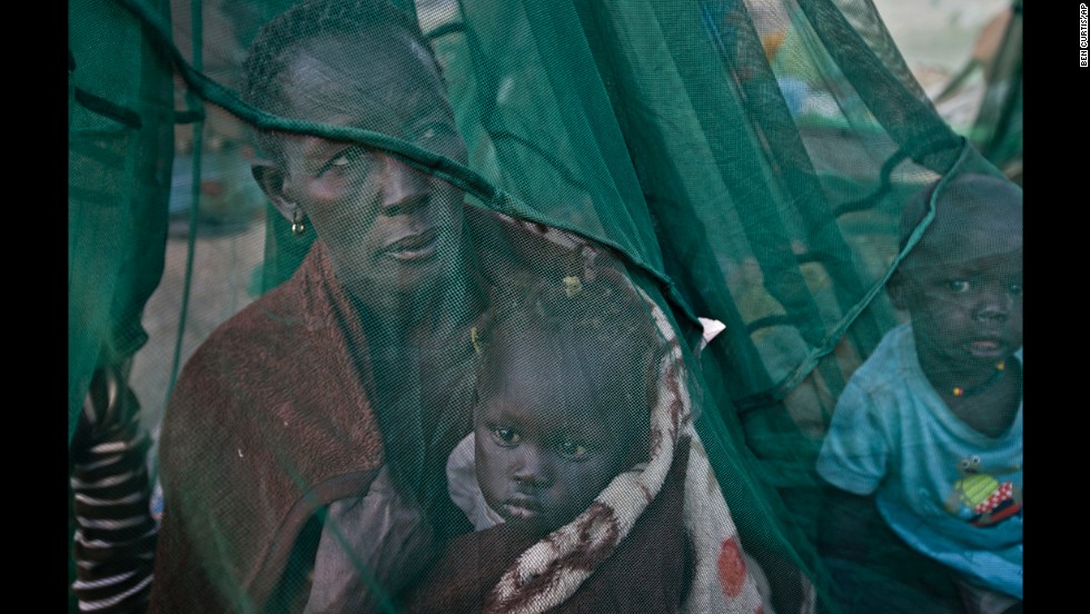 One of the few to have a mosquito net, a displaced family who fled the recent fighting between government and rebel forces in Bor by boat across the White Nile, sit under it in Awerial, South Sudan, on Thursday, January. 2.