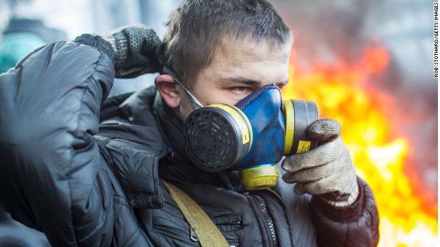 A protestor puts on a gas mask near Dynamo Stadium in Kiev on January 24.