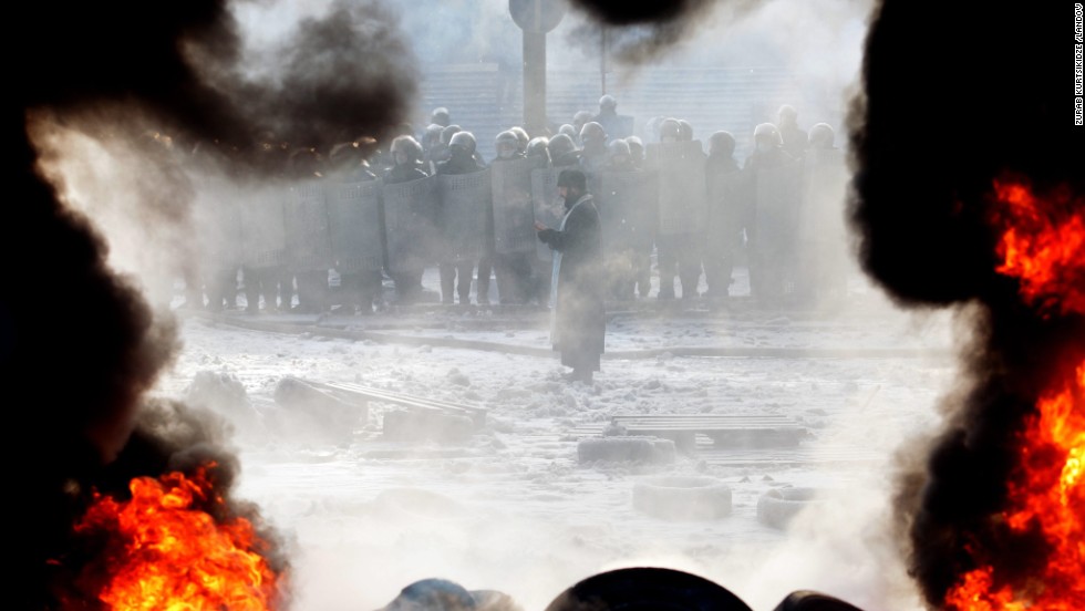 An Orthodox priest prays during protests on January 25.