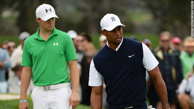 Look who&#39;s behind you! Halfway leader Jordan Spieth (left) watches on as Tiger Woods putts at Torrey Pines.