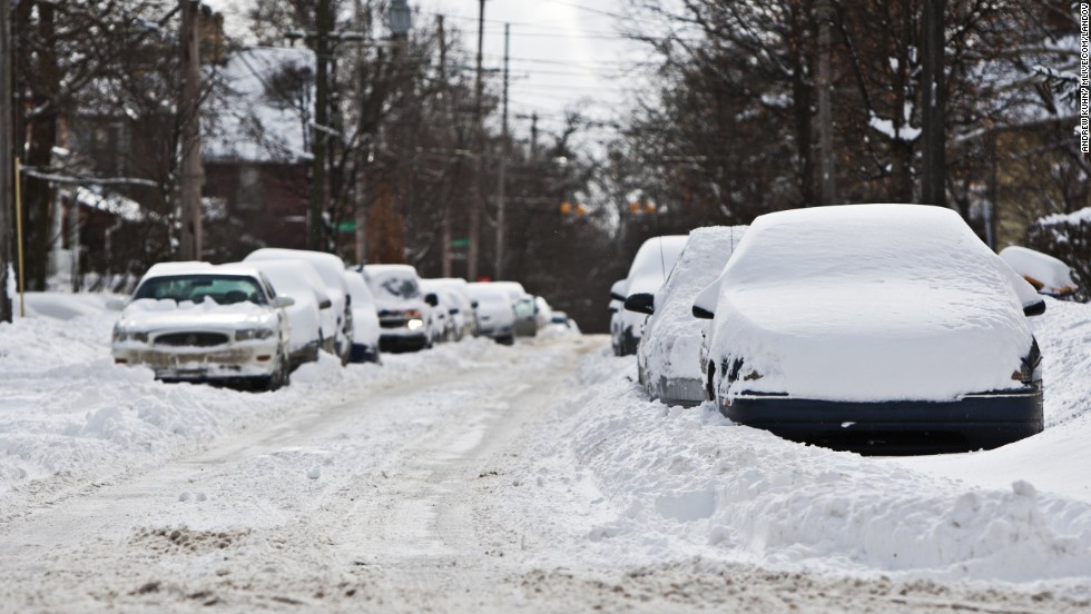 Cars sit in drifts and plowed snow on January 25 in Grand Rapids, Michigan.