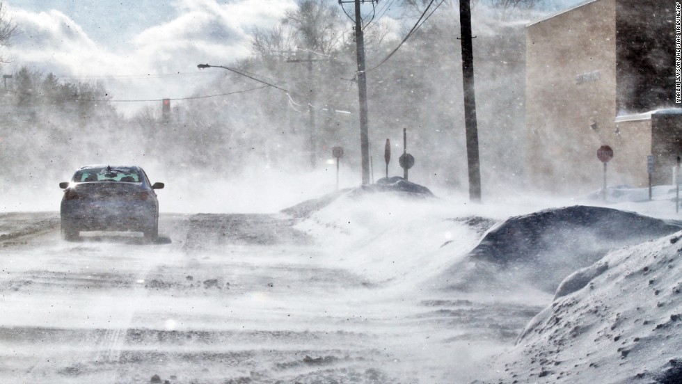 A strong wind kicks up snow Sunday, January 26, in Vadnais Heights, Minnesota, creating drifts over roads and parking lots.