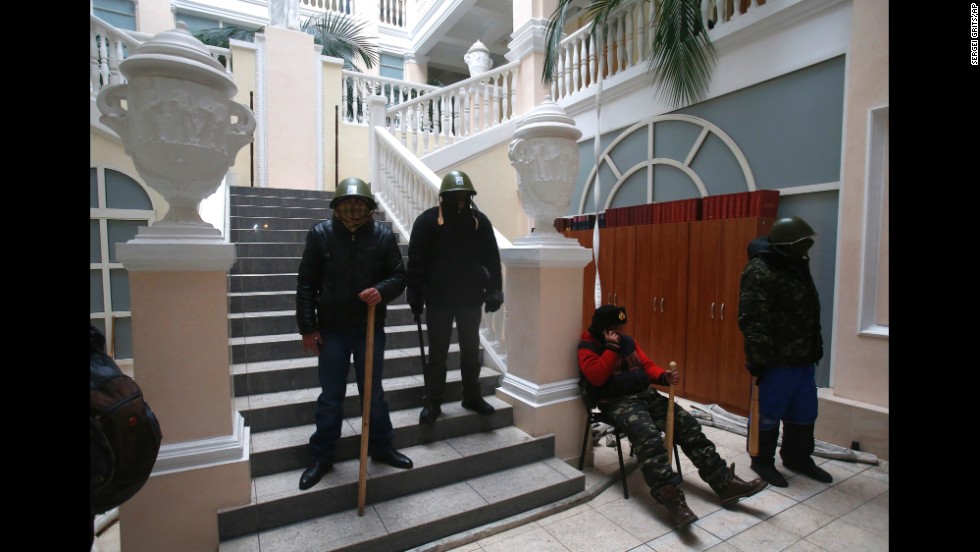 Protesters stand guard inside the Ukraine Justice Ministry in Kiev on January 27. Demonstrators later left the building because they didn&#39;t want to create any difficulties in negotiations between the government and opposition, a protest leader said. Protesters repositioned themselves outside and blocked access to the building, the leader said.