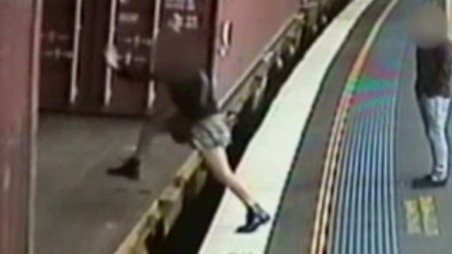 Woman attempts to jump on moving train - CNN Video