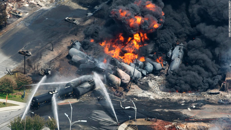 Smoke rises from railway cars after a train derailed in Lac-Megantic, Quebec, Canada, on July 6, 2013. A large swath of Lac-Megantic was destroyed after the derailment sparked several explosions. The train was carrying crude oil. At least 42 of the community&#39;s 6,000 residents died.