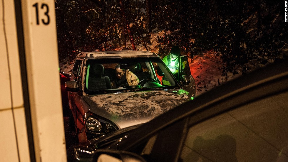 A police officer talks with a crash victim who was involved in a five-car pileup in Sandy Springs, Georgia, early on January 29.