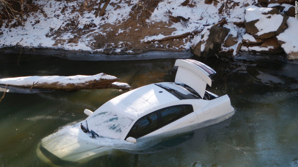 A car lies half submerged in the Cahaba River in Mountain Brook, Alabama, on Thursday, January 30. The driver was able to escape before the car slid into the river during a snow storm on Tuesday and was not injured. A wave of arctic air that started over the Midwest and Plains spread to the Southeast, bringing snow, freezing ice and sleet to a region that doesn&#39;t deal with such weather very often.