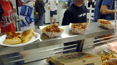 AUSTIN, TX - MARCH 11: Students line up to receive food during lunch in the cafeteria at Bowie High School March 11, 2004 in Austin, Texas. The Austin School District is working to make their cafeteria offerings more healthy, but the most popular foods are still fried chicken strips, pizza, and french fries. Concern about increased levels of childhood obesity in the United States has made the food served in public schools cafeterias a much greater concern. (Photo by Jana Birchum/Getty Images)
