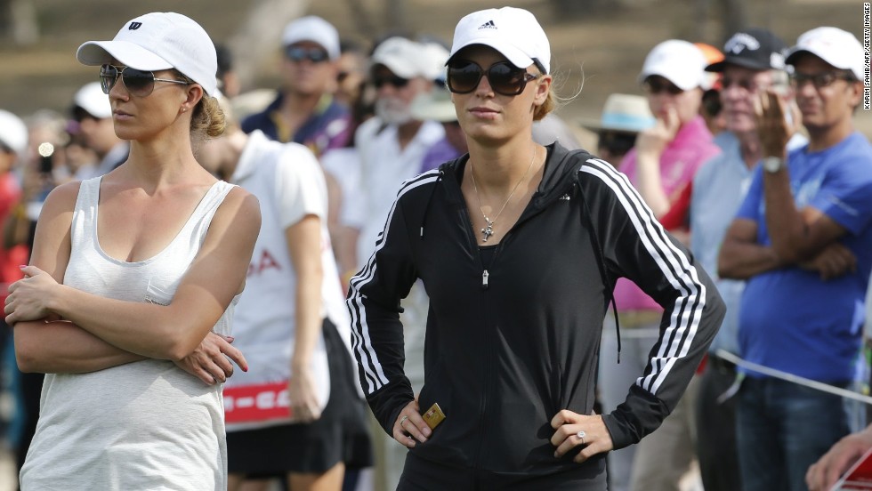 His fiancee, tennis player Caroline Wozniacki, looks on (right) as the Northern Irishman comes close to securing a $2.5 million prize for a hole-in-one at the 17th hole on the Majlis Course.
