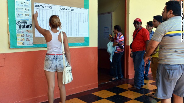A woman looks for her name at a polling station in San Jose during the presidential election, on February 2, 2014. Costa Ricans choose a new president Sunday from a field of four candidates, none of whom have a clear lead in the polls and with nearly a third of voters undecided.