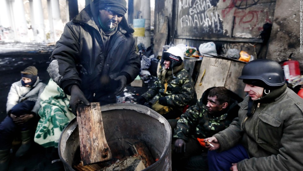 Opposition supporters warm themselves in Kiev on Saturday, February 1.
