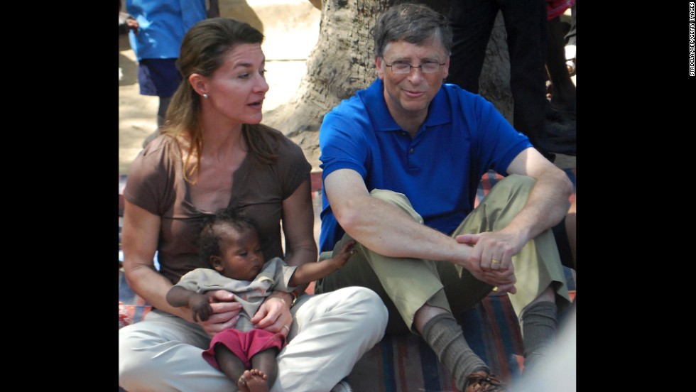Gates looks on as his wife, Melinda, holds a baby during their visit to a village in India&#39;s Bihar state on March 23, 2011. The mission of the Bill &amp;amp; Melinda Gates Foundation is to &quot;unlock the possibility inside every individual,&quot; according to its website.