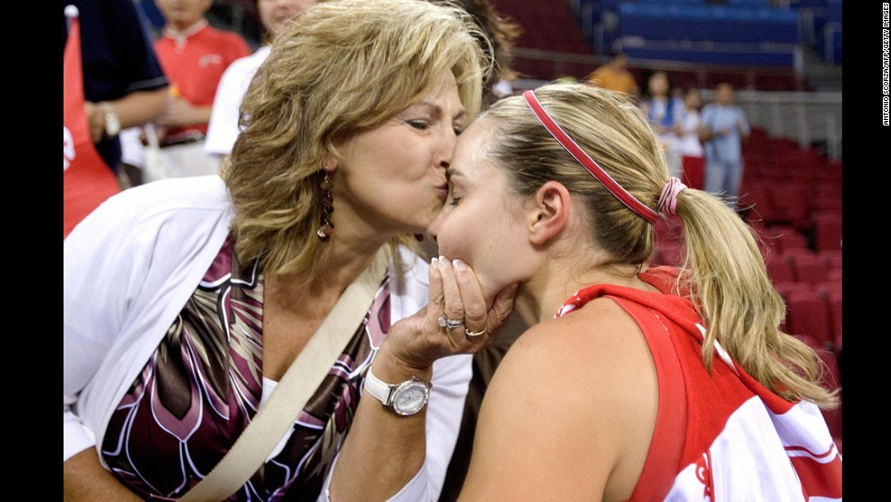 Basketball player Becky Hammon receives a kiss from her mother, Bev, at the...