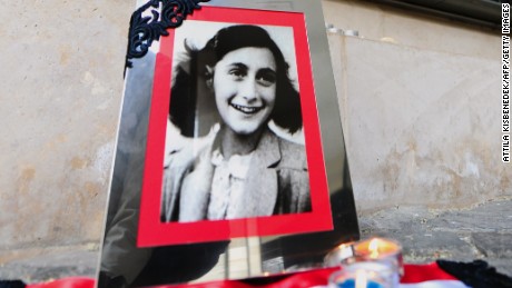 A portrait of Anne Frank stands in front of the memorial of Central Europe&#39;s first Holocaust museum in Budapest.