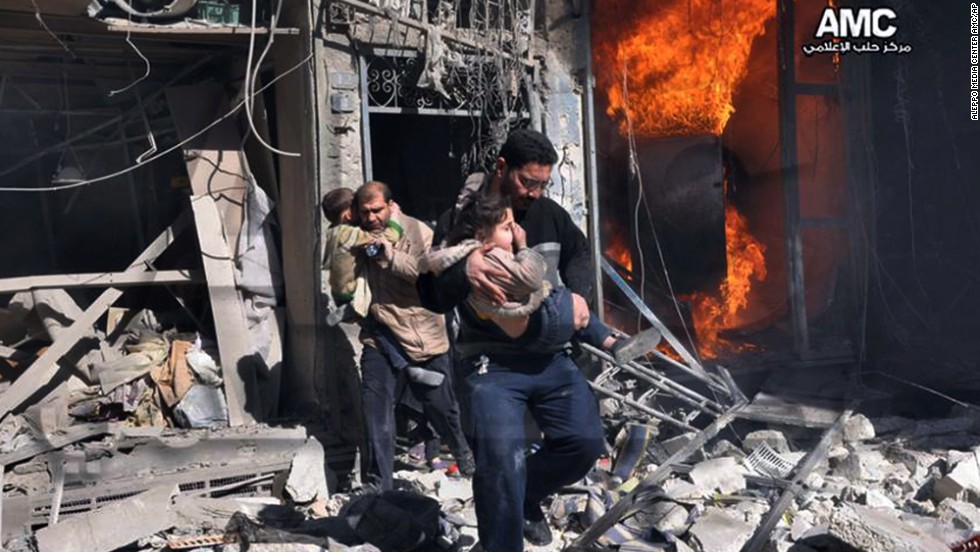 In this photo provided by the anti-government activist group Aleppo Media Center, Syrian men help survivors out of a building in Aleppo after it was bombed, allegedly by a Syrian regime warplane on Saturday, February 8. The United Nations estimates more than 100,000 people have been killed since the Syrian conflict began in March 2011. Click through to see the most compelling images taken during the conflict, which is now a civil war: