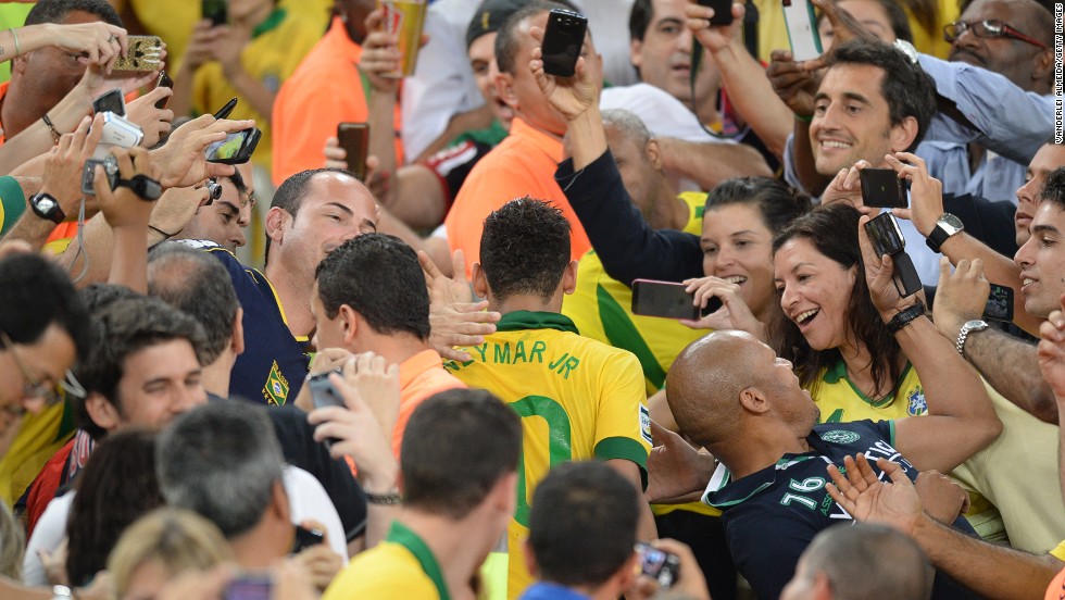 Neymar is mobbed by members of the public in Rio&#39;s Maracana after his starring role -- voted best player in addition to being top goalscorer -- during Brazil&#39;s Confederations Cup triumph on home soil last year. 