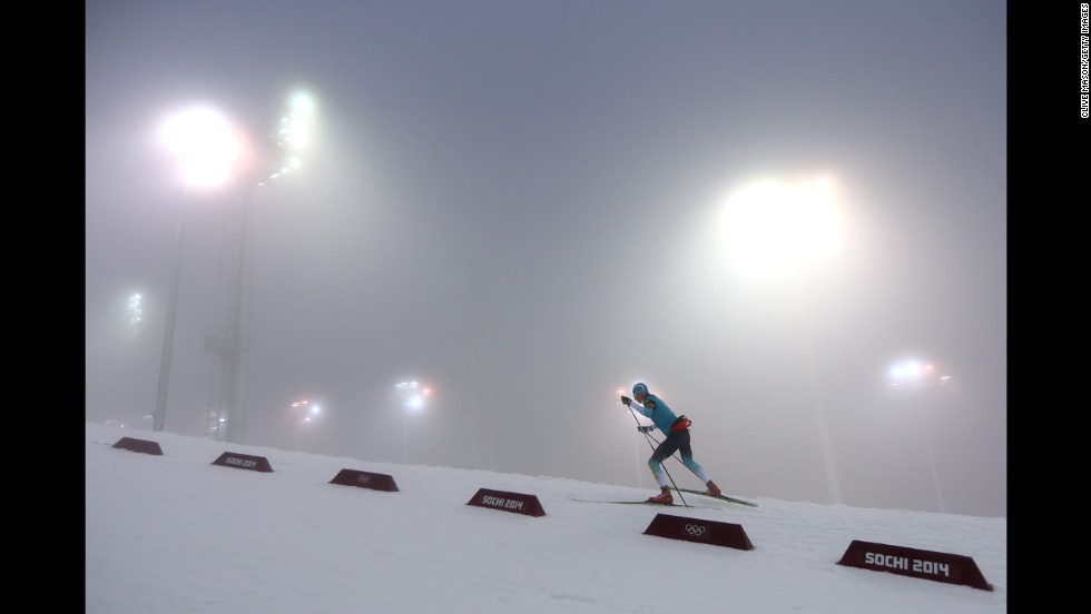 A biathlete warms up for the men&#39;s 15-kilometer mass start event on February 16.