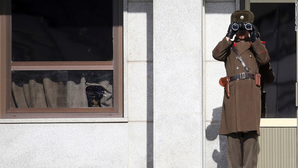 A North Korean soldier uses binoculars on Thursday, February 6, to look at South Korea from the border village of Panmunjom, which has separated the two Koreas since the Korean War. 