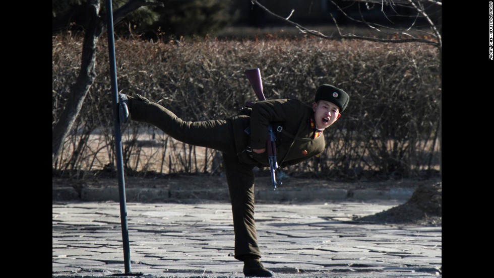 A North Korean soldier kicks a pole along the banks of the Yalu River on Tuesday, February 4.