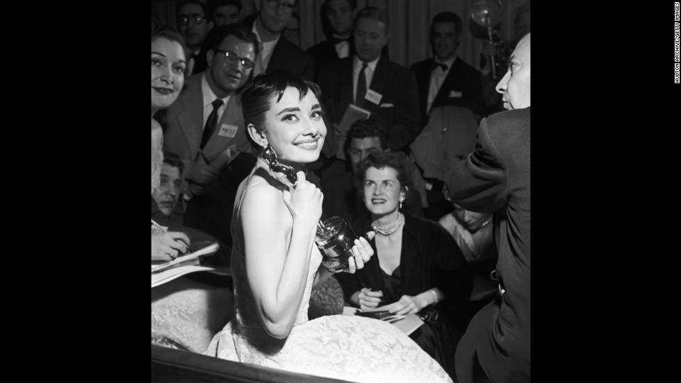 &lt;strong&gt;Audrey Hepburn (1954):&lt;/strong&gt; Audrey Hepburn is surrounded by reporters as she holds her best actress Oscar for &quot;Roman Holiday.&quot;