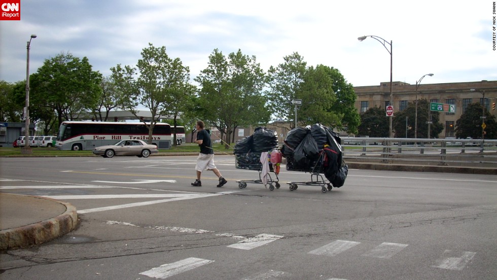 Image result for man pushing shopping cart through city