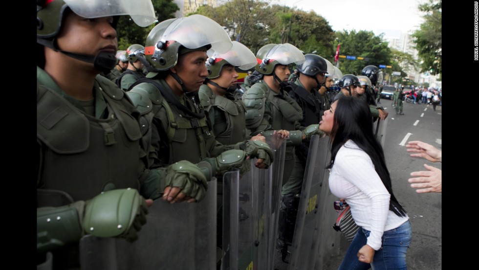 A young woman argues with members of the Venezuelan National Guard during an anti-government protest in Caracas on Monday, February 17.