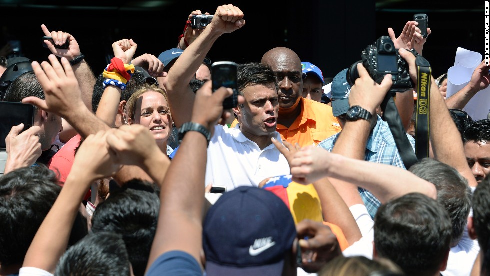 Opposition leader Leopoldo Lopez greets supporters during a demonstration in Caracas on Wednesday, February 12. Lopez was charged with murder, terrorism and arson in connection with the protests, according to his party, Popular Will. Lopez denies the accusations, the party said in a statement.