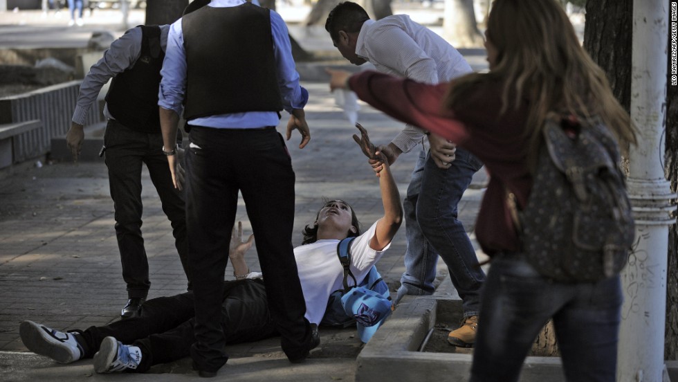 Police detain a student during clashes in Caracas on February 12.