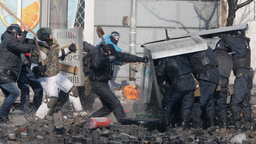 Protesters clash with riot police outside Ukraine&#39;s parliament in Kiev on February 18.