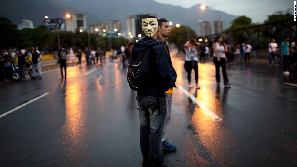 Demonstrators stand on a highway during a protest outside La Carlota airport in Caracas on February 18.