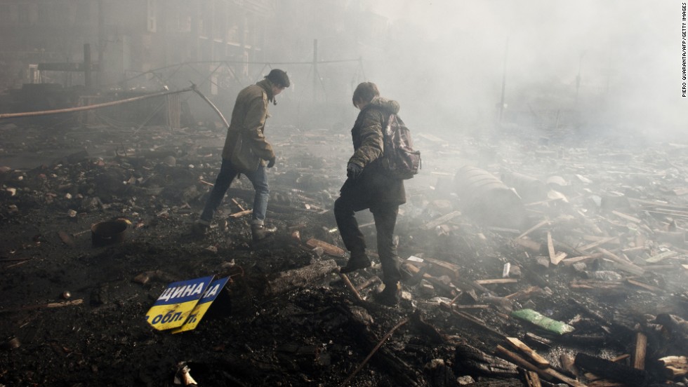 Protesters walk in the rubble of Independence Square on February 19.