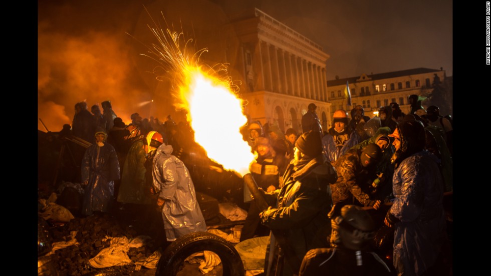 Protesters use a compressed air cannon to launch a Molotov cocktail toward police lines in Independence Square on February 19.