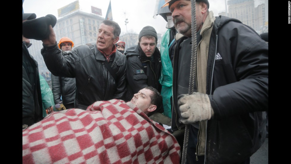 An injured protester is evacuated from Independence Square on February 20.
