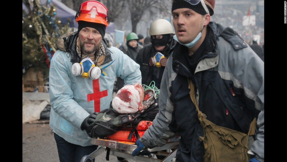 An injured protester is carried away from Independence Square on a stretcher February 20. 