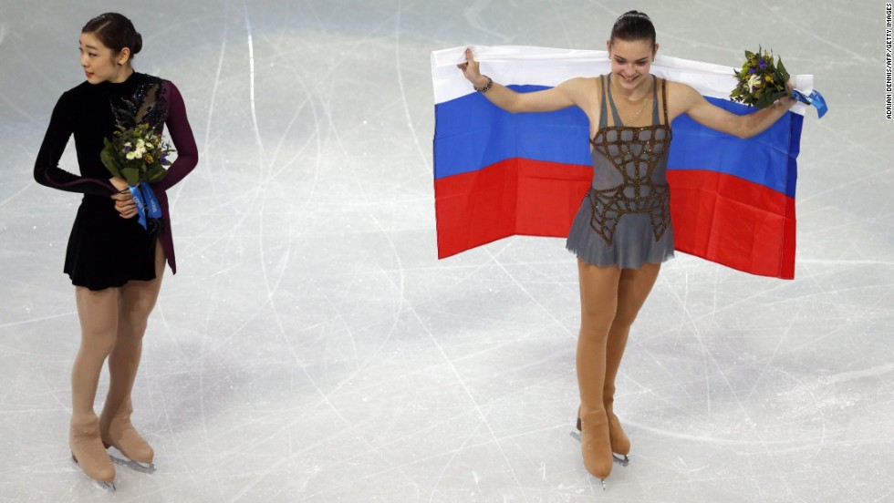 Gold medalist Adelina Sotnikova of Russia, right, and silver medalist Yuna Kim of South Korea take part in the flower ceremony after the women&#39;s free skating program in Sochi, Russia, on Thursday, February 20. Some are questioning the scores given to the skaters since Kim seemingly had a better overall performance.