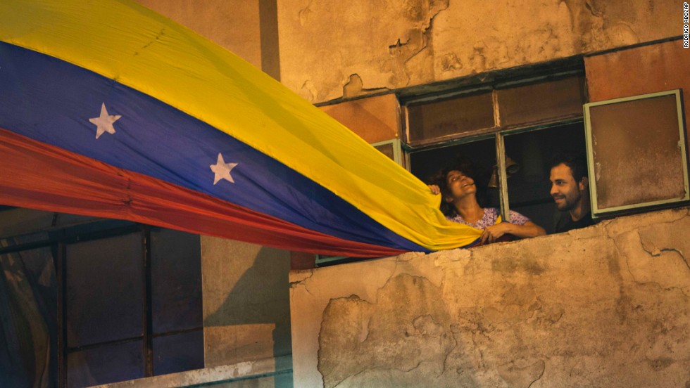 A woman waves a Venezuelan flag out of her Caracas window on February 21.