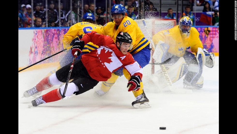 Canada&#39;s Jonathan Toews and Sweden&#39;s Alexander Steen chase the puck during the gold medal game on February 23.
