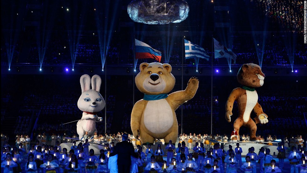 Olympic mascots the Hare, the Polar Bear and the Leopard stand by the extinguished Olympic flame. 
