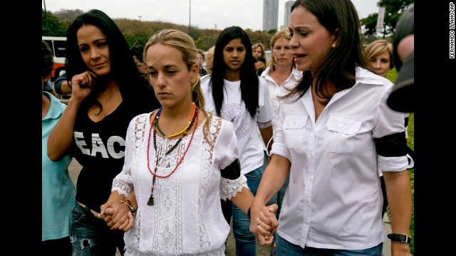 Lilian Tintori, the wife of jailed opposition leader Leopoldo Lopez, center, walks hand in hand with actress Norkys Batista, left, and congresswoman Maria Corina Machado as they arrive for a news conference in Caracas on February 24.