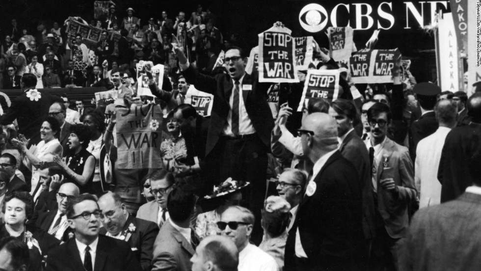 Members of the New York delegation protest against the Vietnam War during the 1968 Democratic National Convention held in Chicago. Outside, riots erupted, with tens of thousands of Vietnam War protesters clashing with Chicago police and National Guard forces.