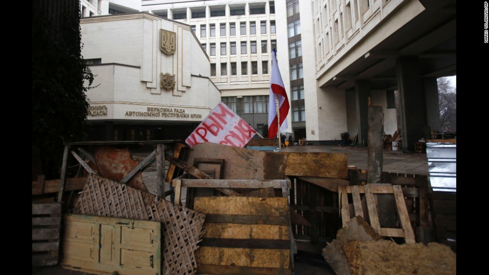 Barricades in front of a government building in Simferopol on February 27 hold a banner that reads: &quot;Crimea Russia.&quot; There&#39;s a broad divide between those who support the pro-Western developments in Kiev and those who back Russia&#39;s continued influence in Crimea and across Ukraine.