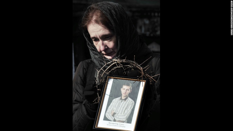 On February 26 in Kiev, a woman holds a photograph of a protester killed during the height of tensions.