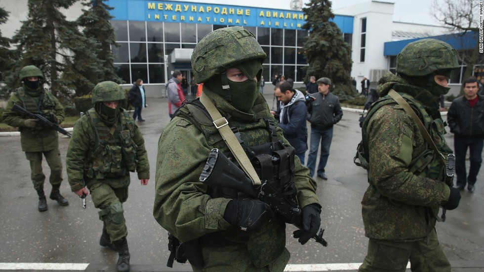 Armed men patrol outside the Simferopol International Airport on Friday, February 28.